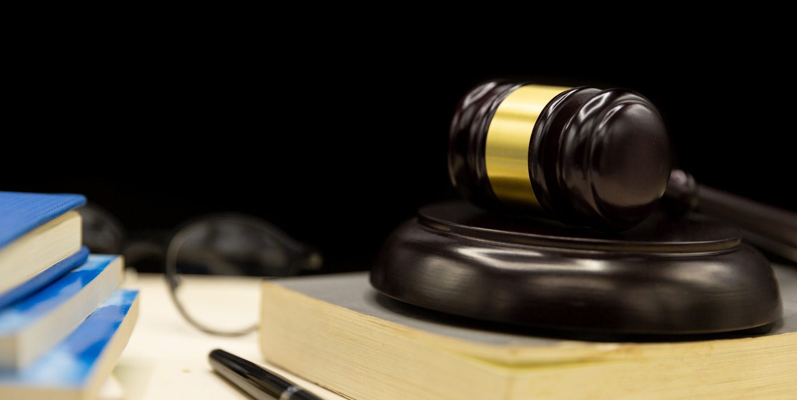 Judges gavel on book and wooden table. Law and justice concept b