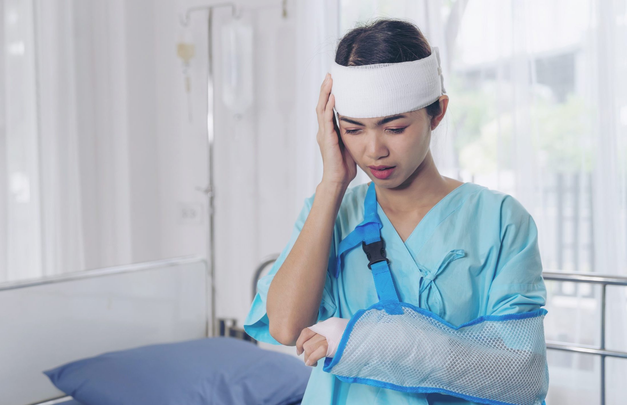 Lonely accident patients injury headache woman in hospital - medical concept