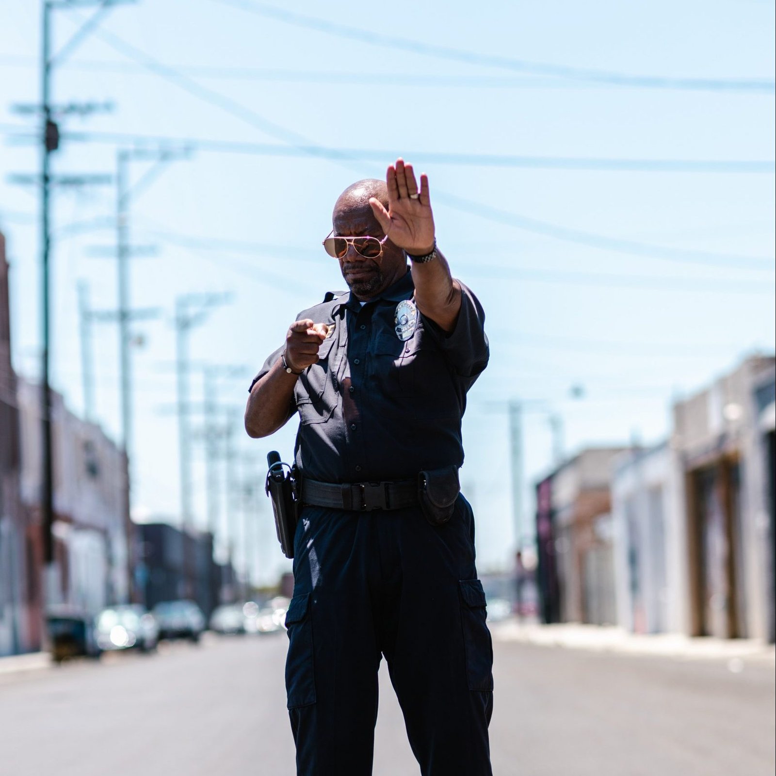 police officer in the middle of the street tellinh to stop