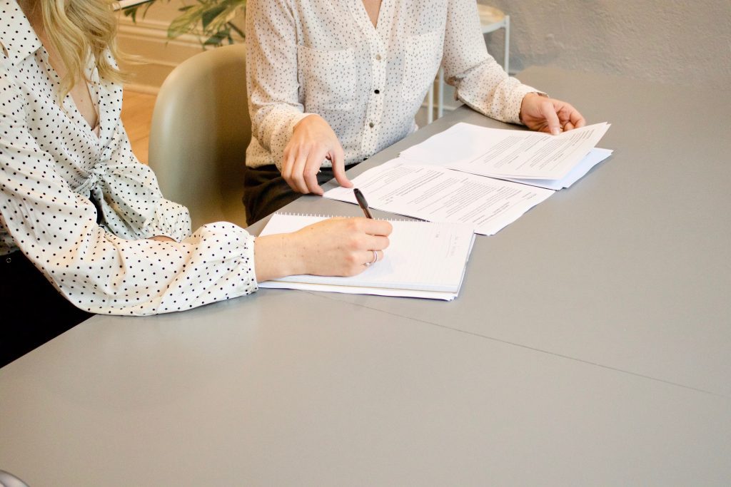 Women signing a paper