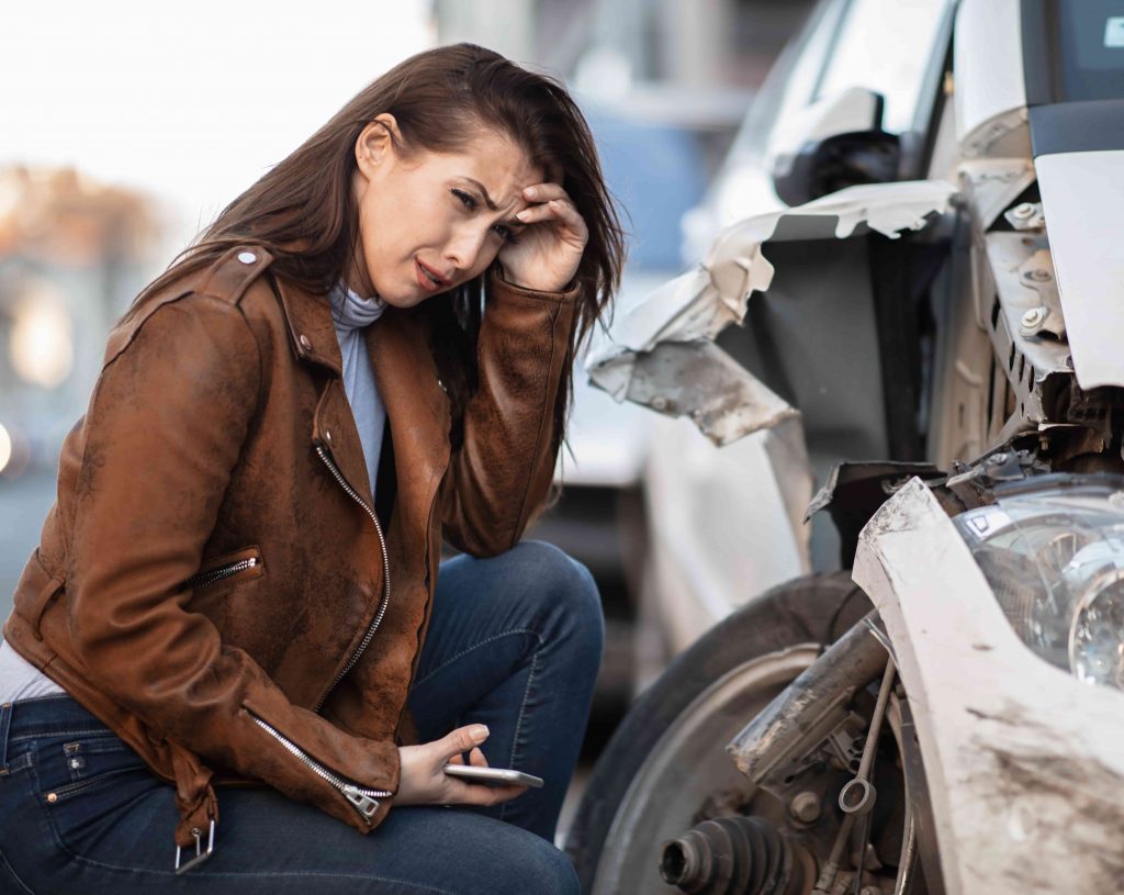 young-woman-despair-crying-her-wrecked-car-min