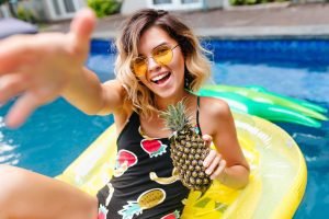 a woman having fun in the pool on a raft